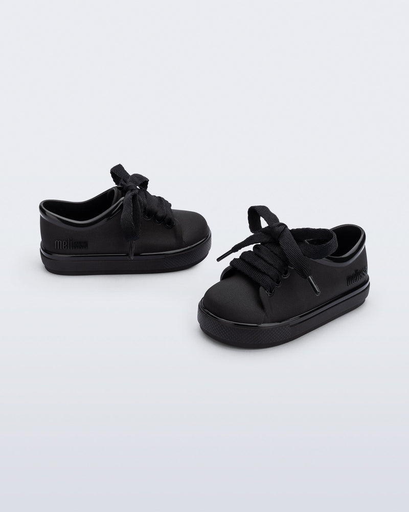 Side and angled view of a pair of black baby Hip Sneakers