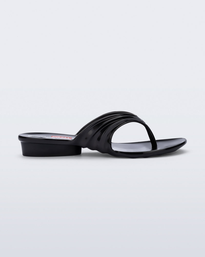 Side view of a black Flip Flop + Diesel sandals