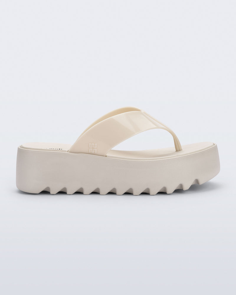 Side view of a beige Thong Platform flip flop