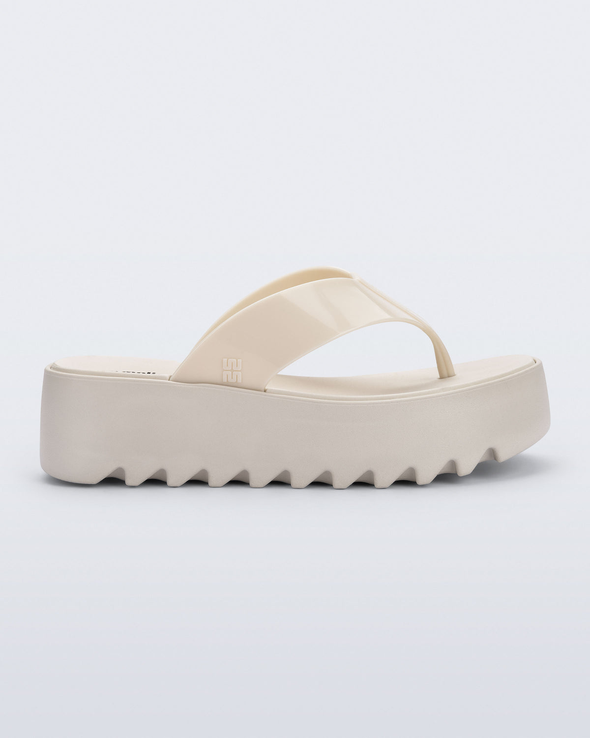 Side view of a beige Thong Platform flip flop