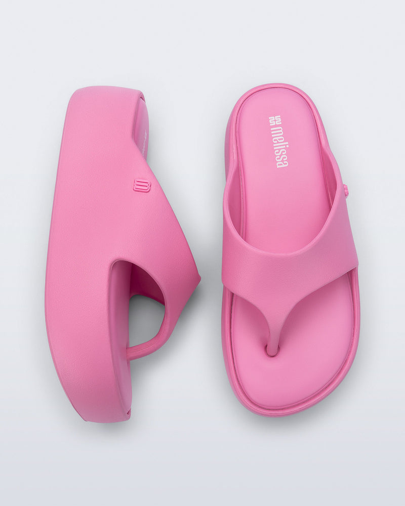 Side and top view of a pair of pink Free Platform Thong sandals