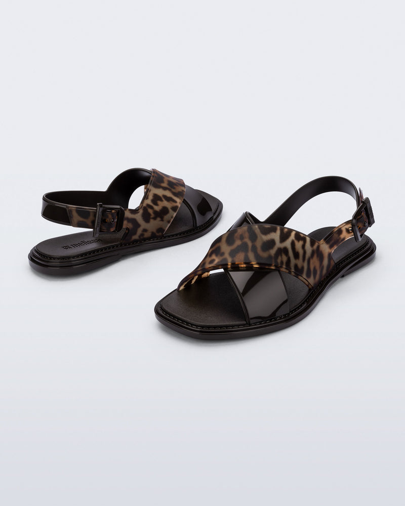 Back and angled view of a pair of brown/tortoise Cleo sandals with back strap and crisscross top straps