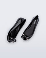 Side and top view of a pair of black Sweet Love Glam ballerina flats with chrome bow