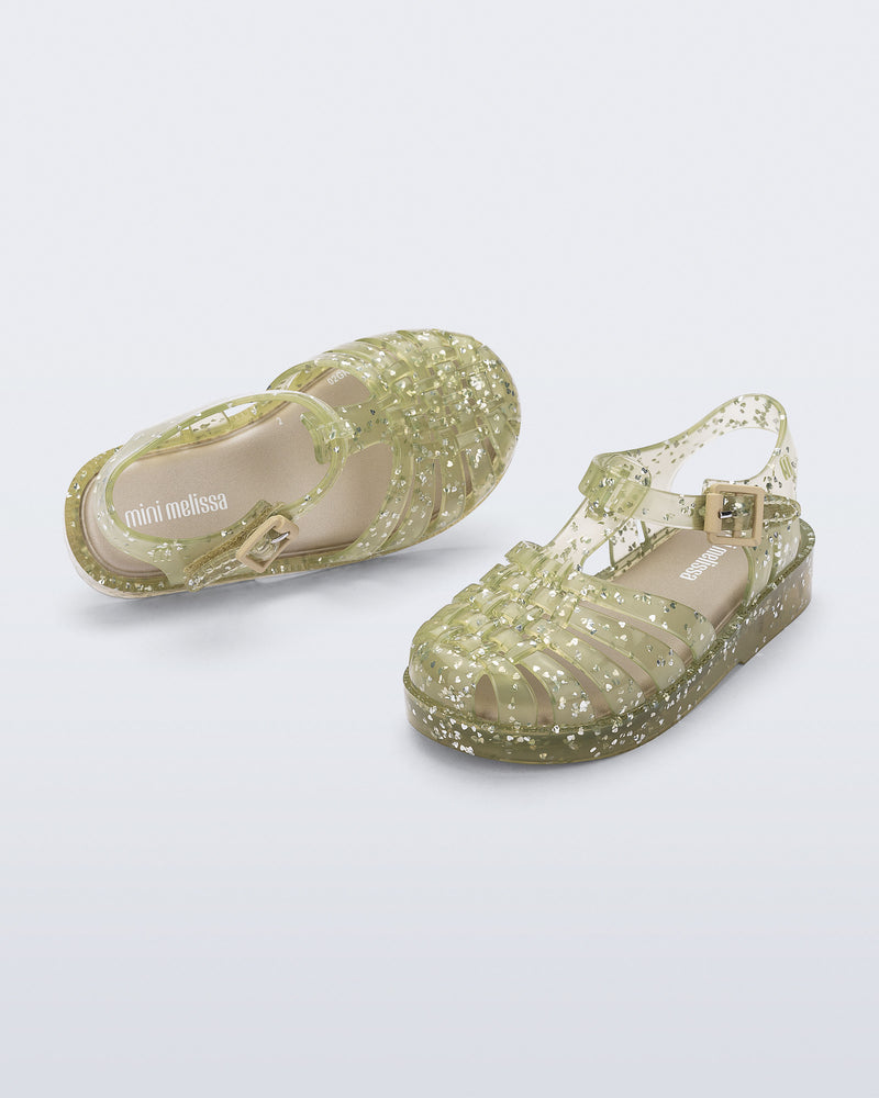 Top and angled view of a pair of yellow Possession Elements baby sandal with glitter hearts