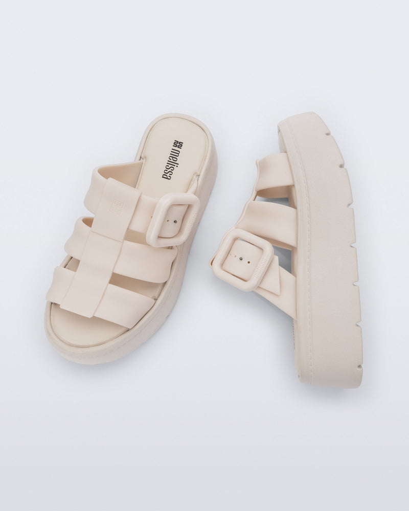 Top and side view of a pair of beige Pump Platform sandals