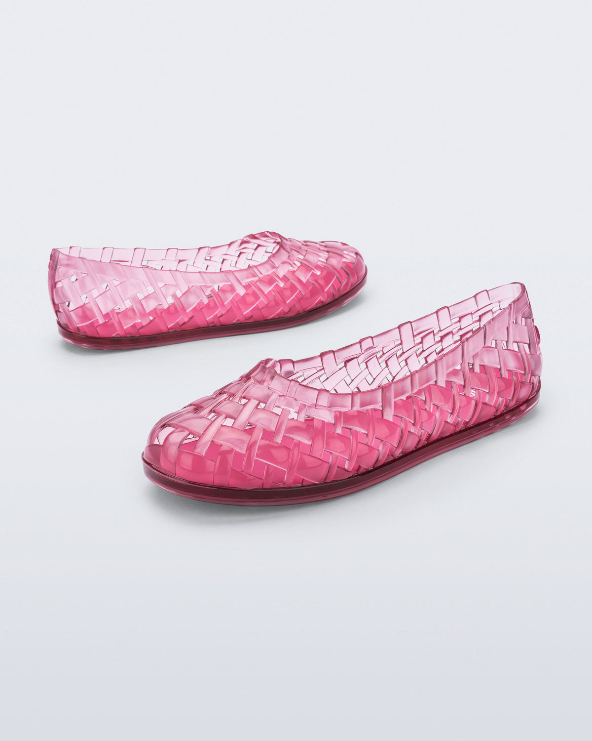 Angled and side view of a pair of clear pink Possession Ballerina flats