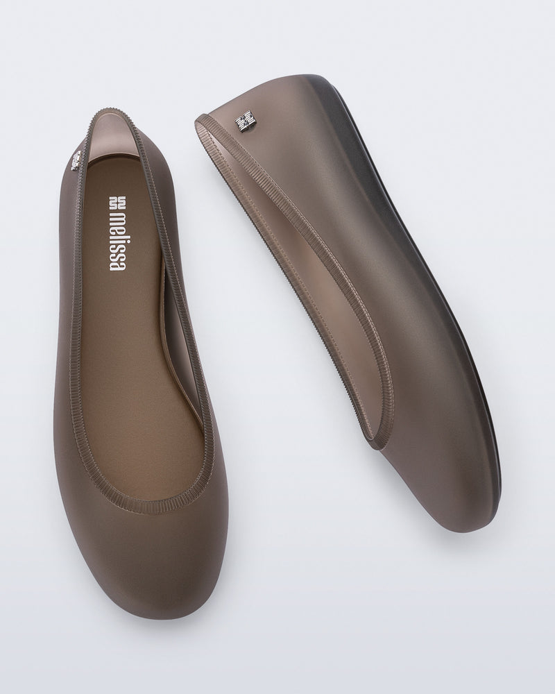 Top and side view of a pair of clear brown Soft Ballerina Essential flats