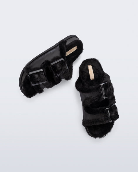 Top and side view of a pair of black Cozy Warm Slides with black fuzzy insoles