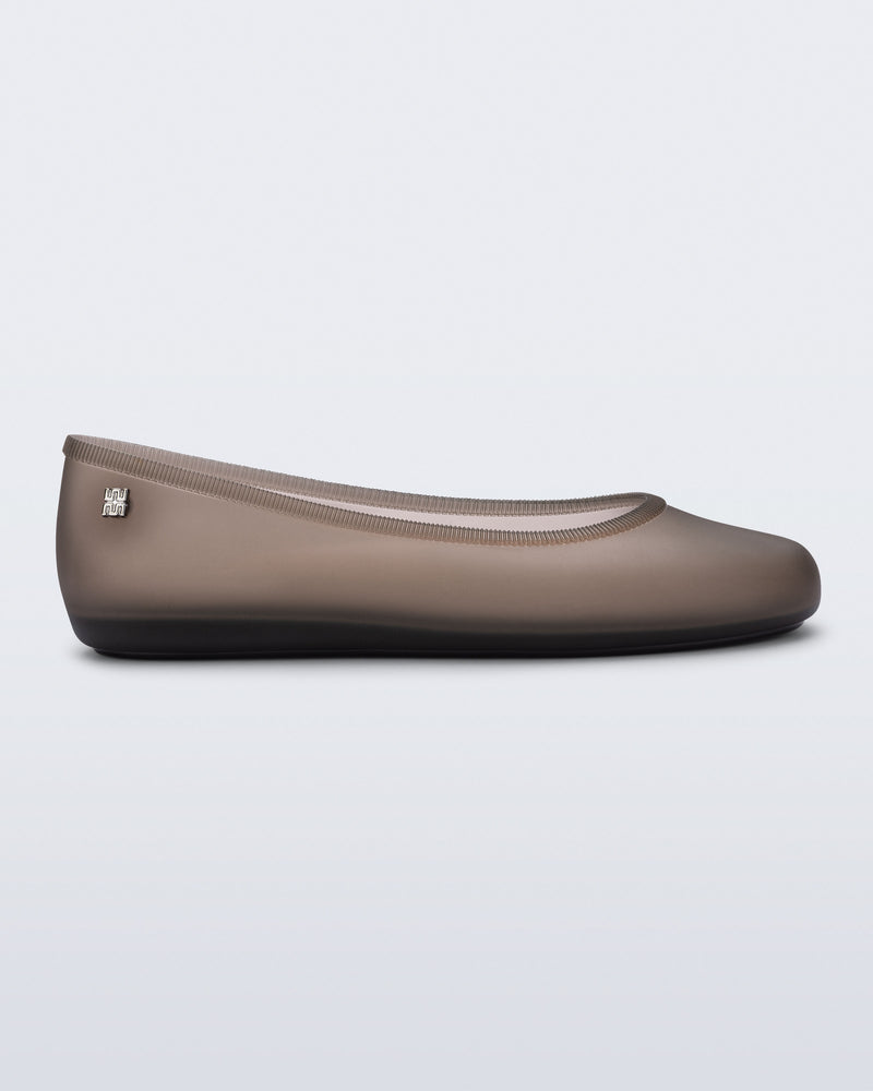 Side view of a clear brown Soft Ballerina Essential Flat