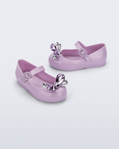 Angled and side view of a pair of lilac Sweet Love Glam baby ballerinas with bow