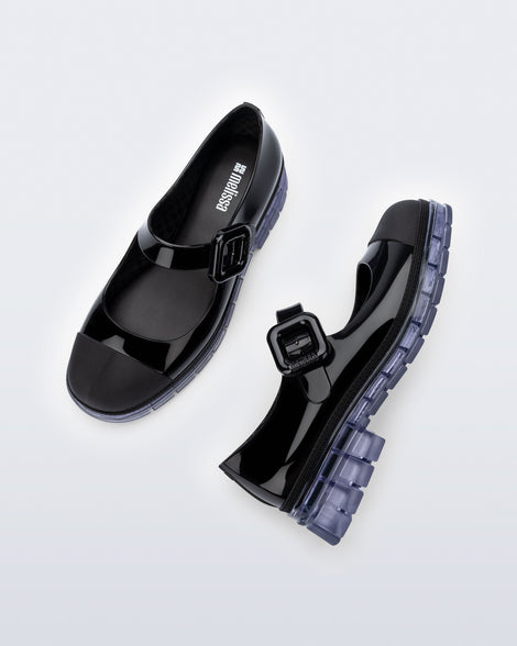 Top and side view of a pair of black with clear sole June mary janes with matte toe cap