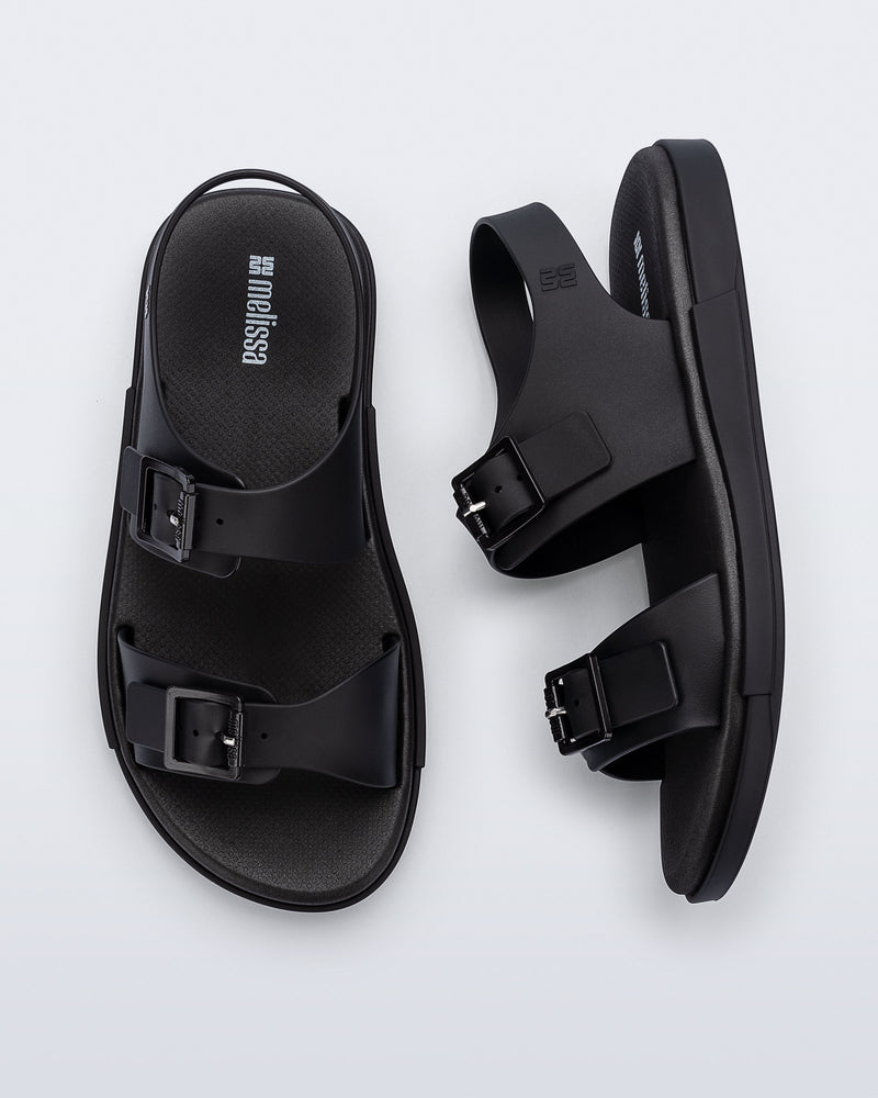 Side and top view of a pair of black Wave Sandals with two straps with buckles and a back strap