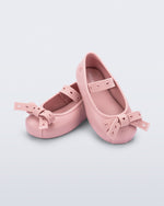 Angled view of a pair of pink Sophie Crush baby ballerina flats with bow
