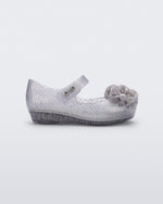 Side view of a clear grey glitter Ultragirl Springtime baby flat with grey flower and peep toe.