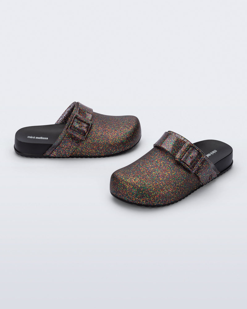 Side and angled view of a pair of mixed glitter/black Cozy Clog for kids