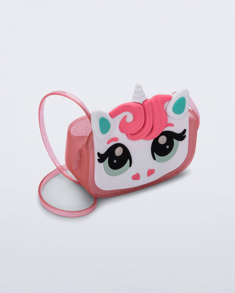 Angled view of a pink glitter Dreamy Unicorn kids bag with a unicorn face on front with pink hair