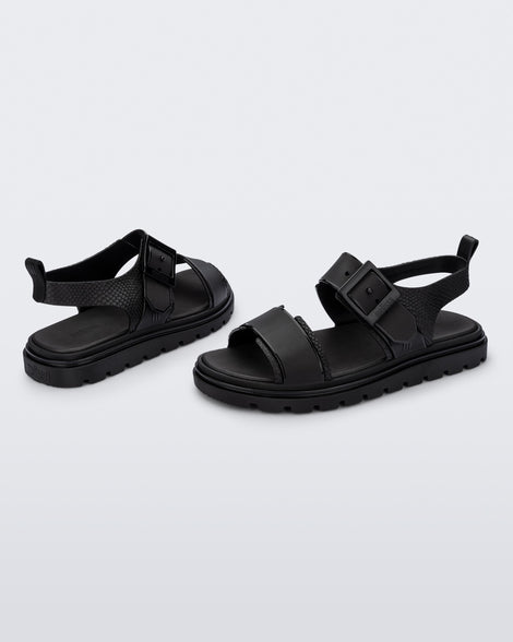 Angled view of a pair of black Connection Papete sandals