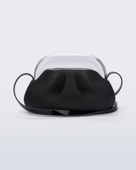 Back view of a small black bag with clear clutch and long strap