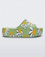 Side view of a green Free Print Platform slide with a white and yellow flower print.