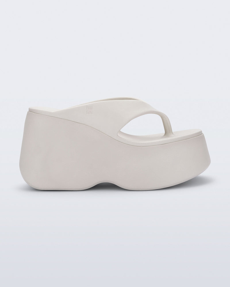 Side view of a beige Free Thong Wedge Platform heel