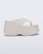 Side view of a beige Free Thong Wedge Platform heel