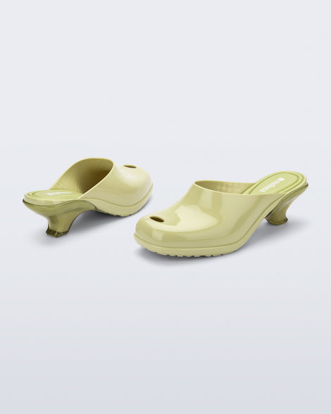 Back and angled view of a pair of green Gaia kitten heels with peep toe