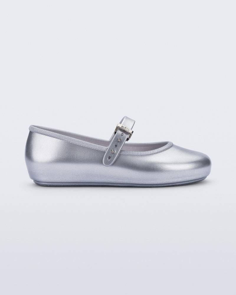 Side view of a pair of silver Soft Ballerina kids flat