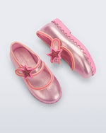 Side and top view of a pair of pearly pink Hip Ballerina Star baby flats with star on upper strap