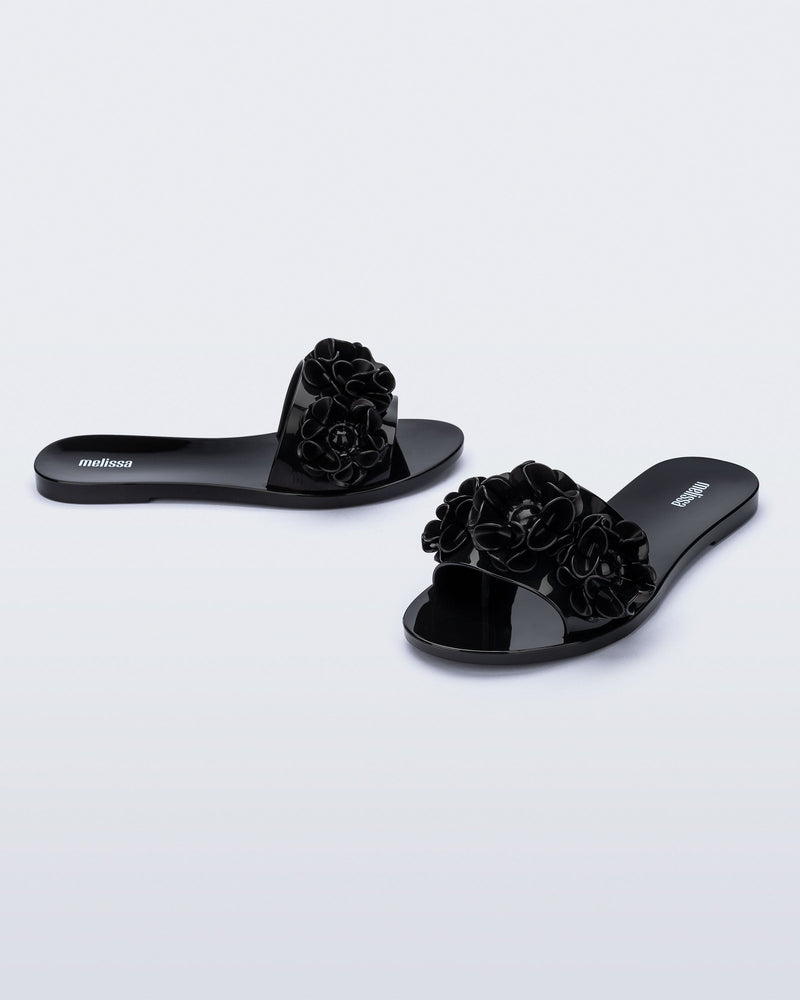 Angled view of a pair of black Babe Springtime slides.