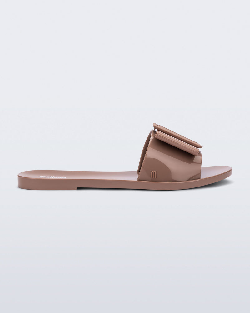 Side view of a tan Babe slide sandal