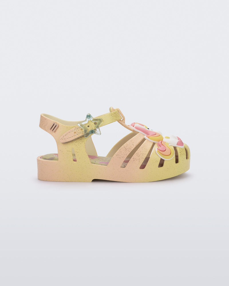 Side view of a yellow/pink Possession Unicorn baby sandal with unicorn on front upper