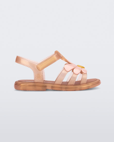 Side view of a pearly brown baby Hip Bloomy sandal with pink flower