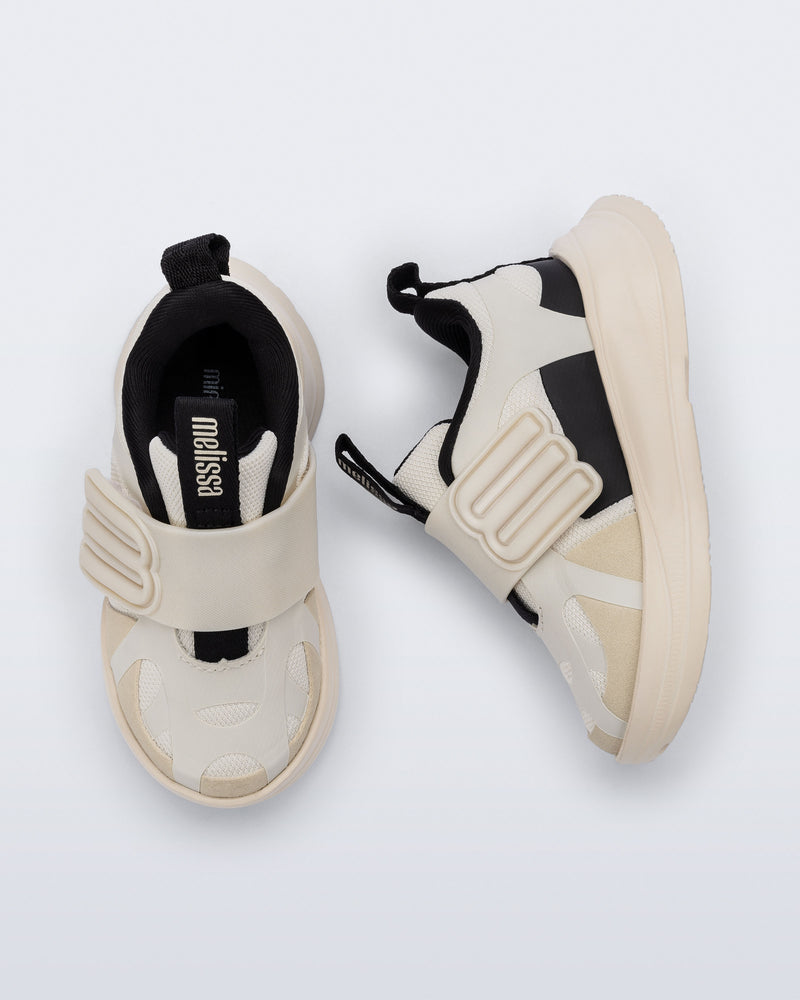 Side and top view of a pair of off white X Beat baby sneakers with black trim