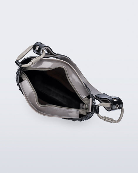 Top view of a black Nina Bag + Alexandre Pavao shoulder bag with grey accents