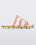 Side view of a pink Path adult sandal with green sole