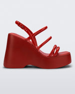 Side view of a red Jessie platform wedge sandal with side buckle ankle strap