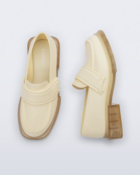 Top and side view of a pair of beige Spencer loafers with clear beige soles