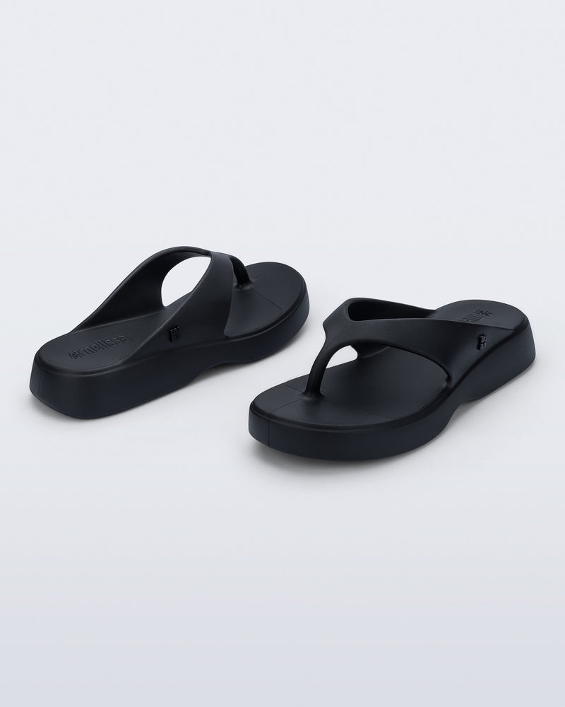 Angled view of a pair of black Free Thong Low Flip Flops
