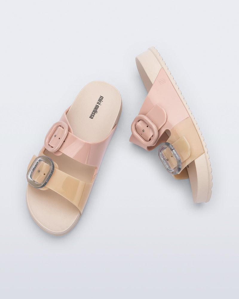 Top and side view of a pair of pink/beige Cozy kids slides
