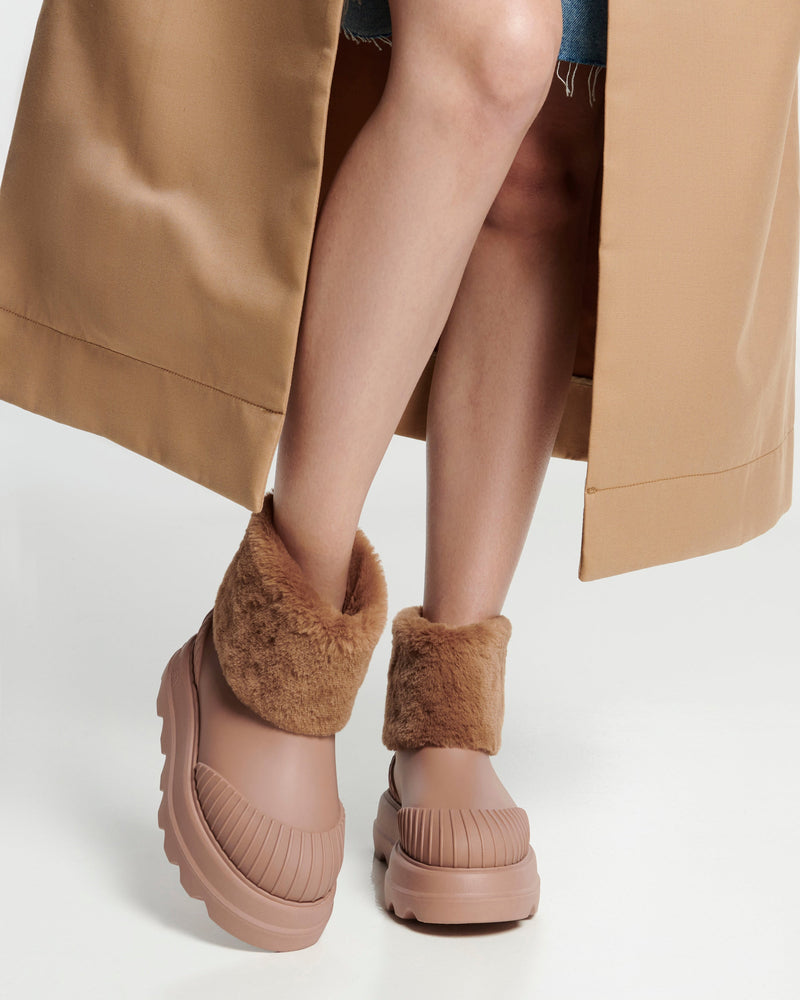Model's legs wearing a pair of brown Warm boots with fuzzy cuff and insole