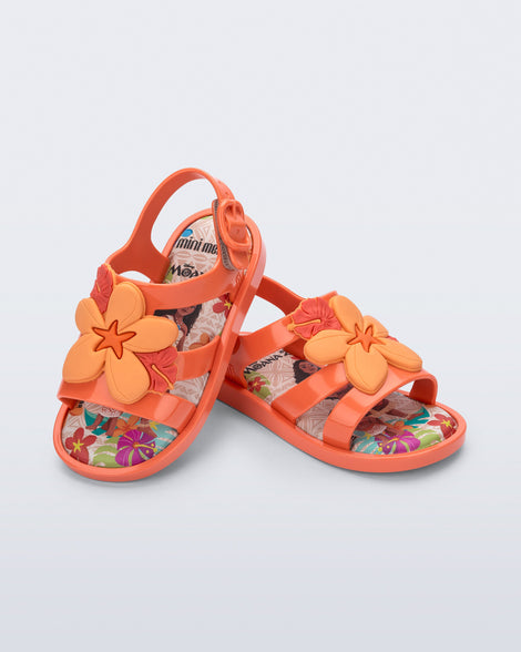 Angled view of a pair of orange Colorland Moana baby sandals