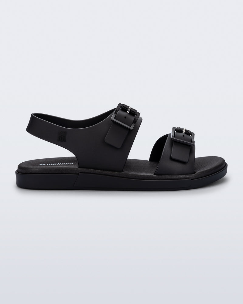 Side view of a black Wave Sandal with two straps with buckles and a back strap