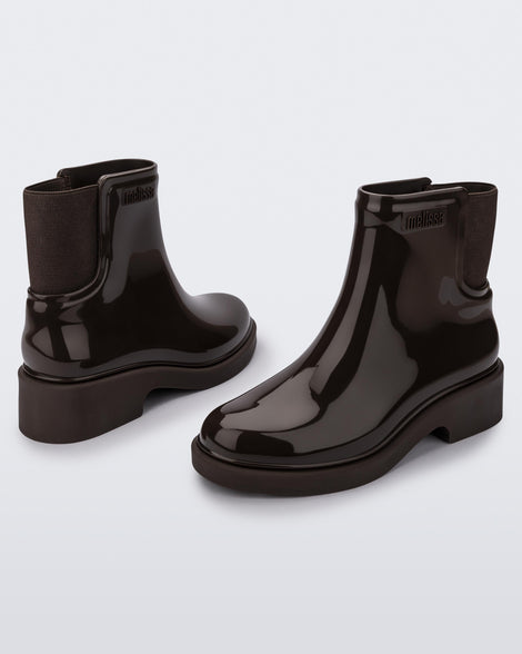Back and angled view of a pair of dark brown Chelsea boots