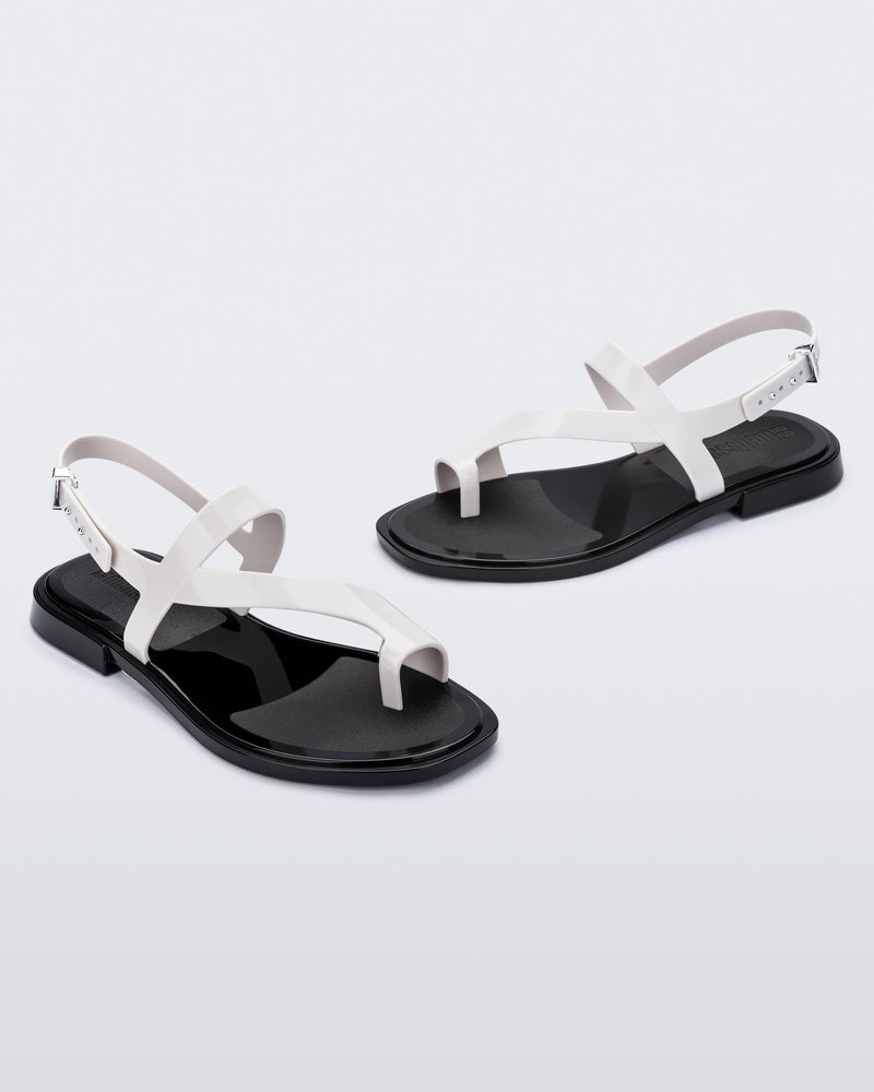 Angled view of pair of white Cassie sandals.