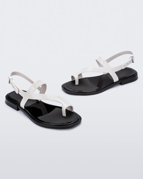 Angled view of pair of white Cassie sandals.