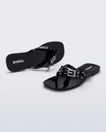 Side and angled view of a pair of black Harmonic Squared flip flops with bow on strap