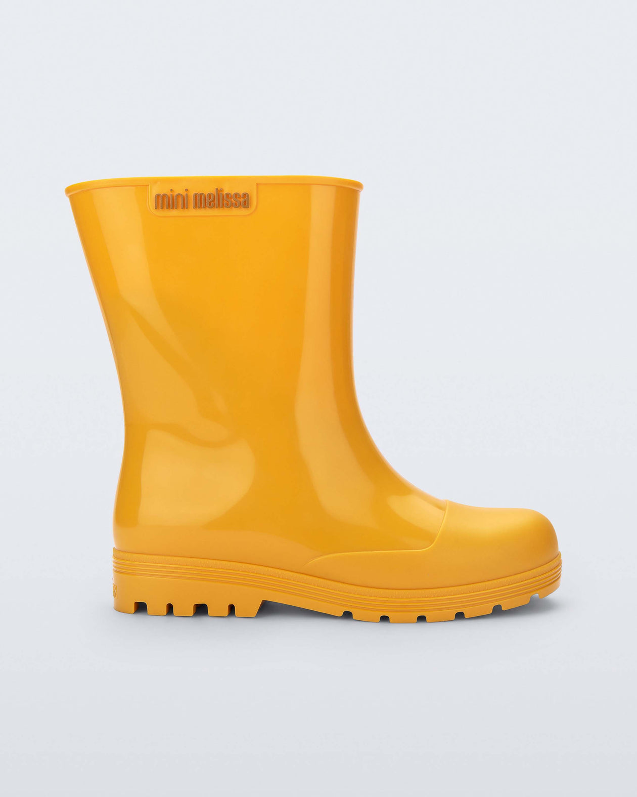 Side view of an orange Welly kids rainboot