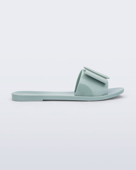 Side view of a blue green Babe slide sandal