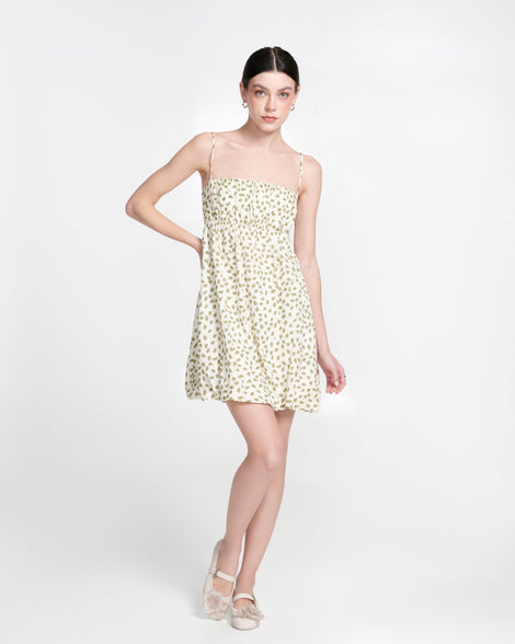 Model in a patterned dress wearing a pair of beige Soft Ballerina Petals flats
