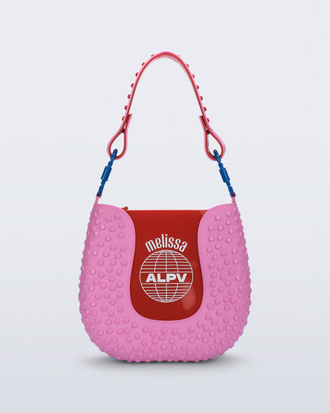 Front view of a pink Nina Bag + Alexandre Pavao shoulder bag with red accents